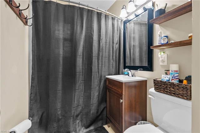 bathroom with vanity, a shower with shower curtain, and toilet