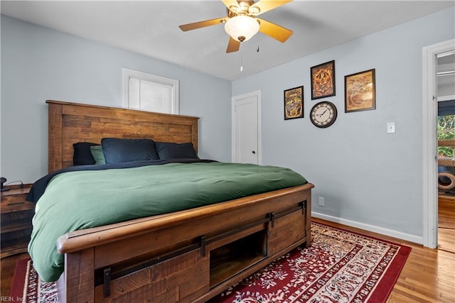 bedroom with ceiling fan and wood-type flooring