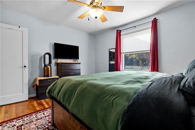 bedroom with ceiling fan and wood-type flooring