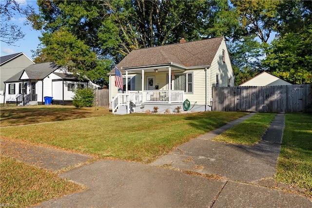 bungalow featuring a porch and a front lawn