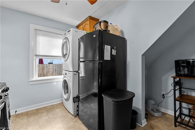 kitchen featuring black refrigerator, ceiling fan, light brown cabinetry, stainless steel range, and stacked washer / dryer