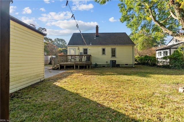 rear view of property featuring a wooden deck, cooling unit, and a lawn