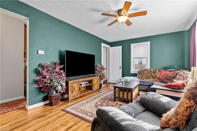 living room featuring ceiling fan and hardwood / wood-style flooring