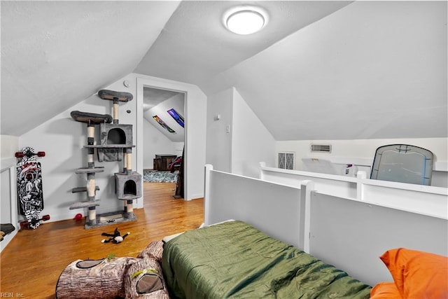 bedroom featuring light hardwood / wood-style flooring and vaulted ceiling