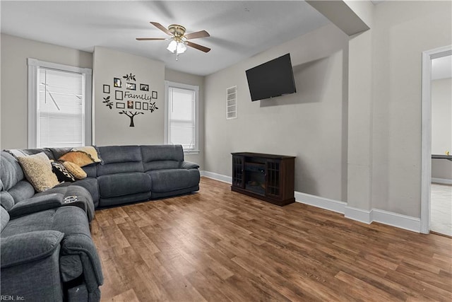 living room with hardwood / wood-style floors and ceiling fan