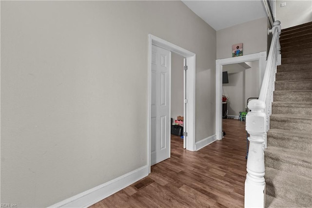 hallway with wood-type flooring