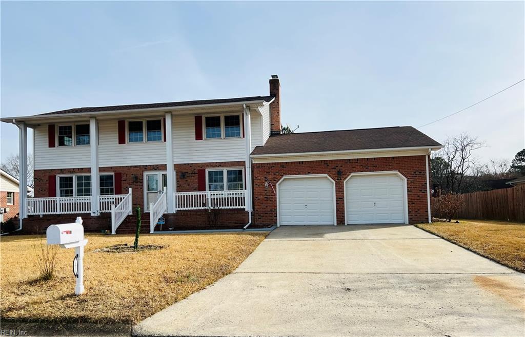 front facade featuring a garage and a front lawn