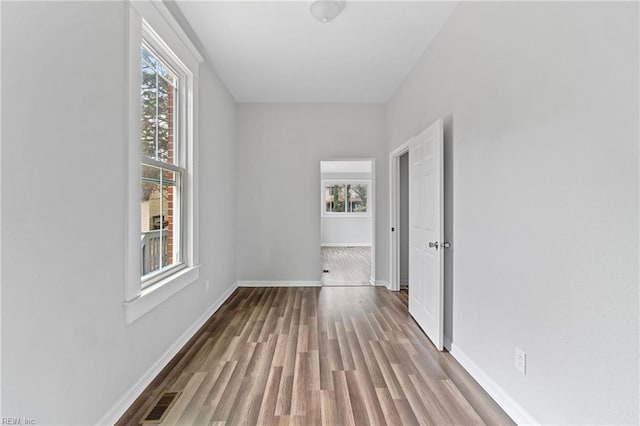 corridor with light hardwood / wood-style floors