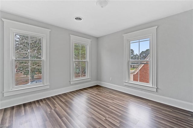 unfurnished room featuring dark hardwood / wood-style floors