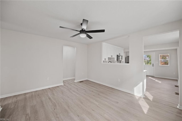 unfurnished room with ceiling fan and light hardwood / wood-style floors