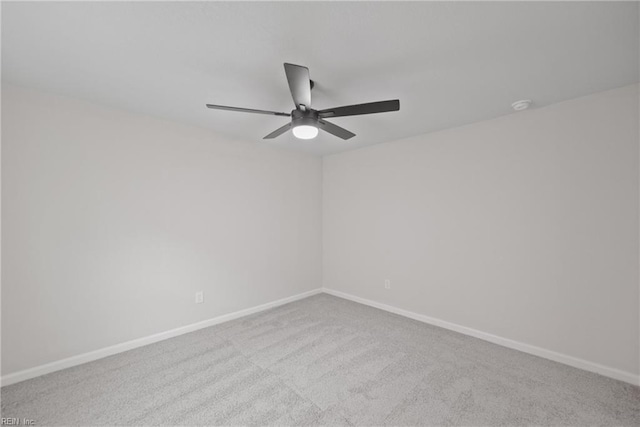 spare room with ceiling fan and light colored carpet