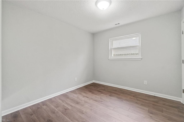 unfurnished room featuring hardwood / wood-style floors