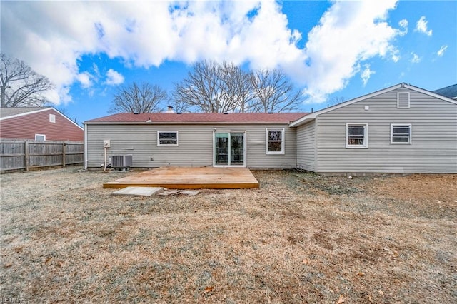 back of house with central air condition unit and a wooden deck