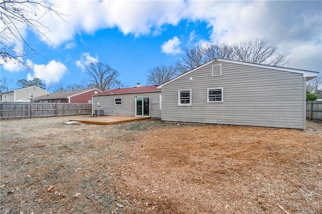 rear view of property featuring cooling unit and a deck