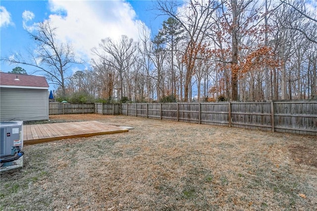 view of yard featuring central air condition unit and a wooden deck