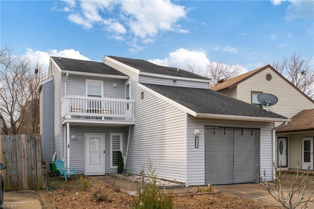 view of front of house featuring a garage and a balcony