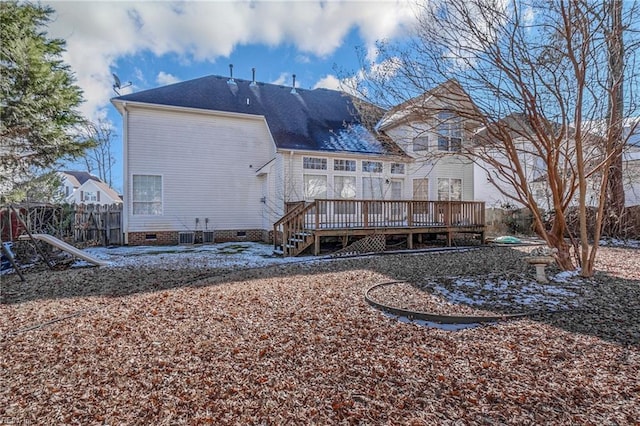 rear view of property featuring a wooden deck