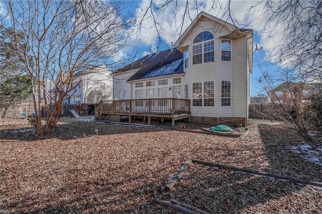 rear view of house featuring a deck