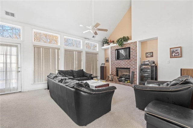 carpeted living room with a fireplace, high vaulted ceiling, and ceiling fan