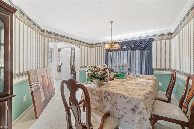 dining area featuring crown molding and a notable chandelier