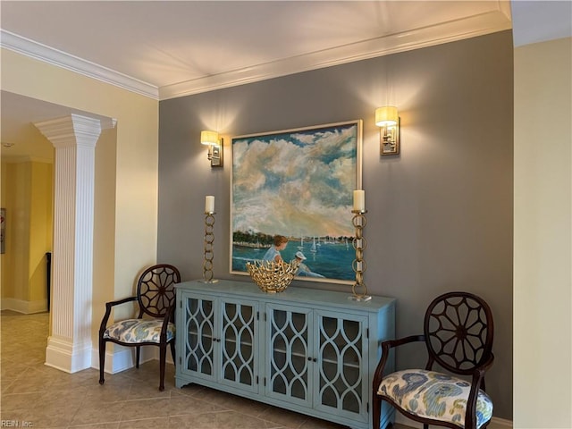 sitting room with tile patterned flooring, crown molding, and decorative columns