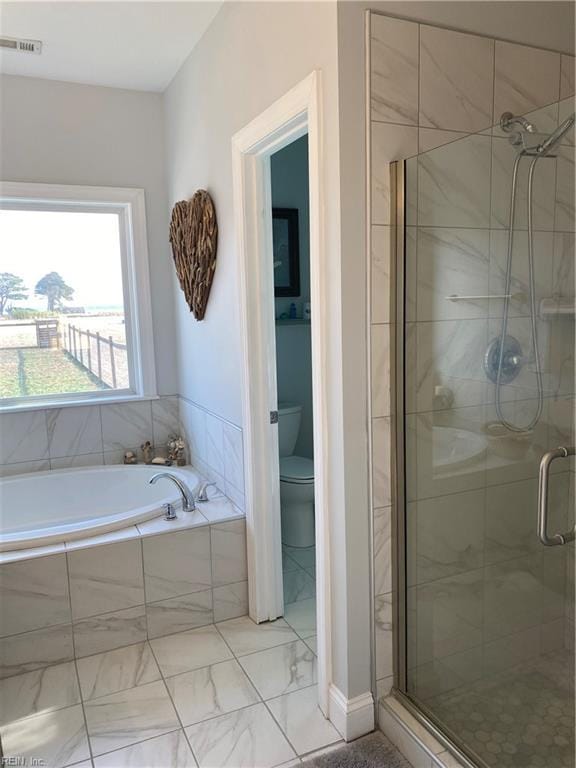 bathroom with toilet and separate shower and tub