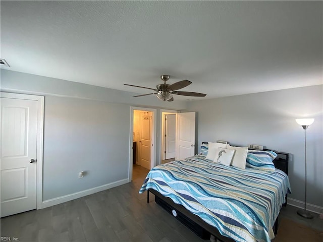 bedroom with ceiling fan and dark hardwood / wood-style floors