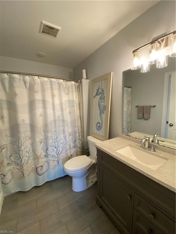 bathroom with toilet and vanity