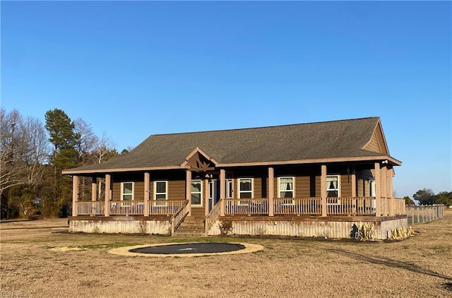 view of front of home with a porch and a front yard