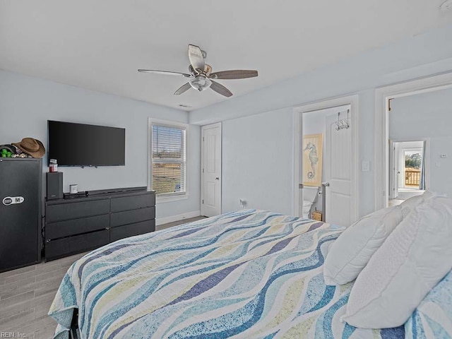 bedroom with ceiling fan, connected bathroom, and light hardwood / wood-style floors