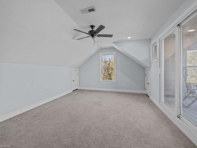 bonus room with ceiling fan, vaulted ceiling, and carpet flooring