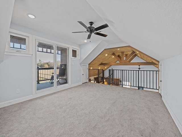 additional living space featuring ceiling fan, carpet, and vaulted ceiling