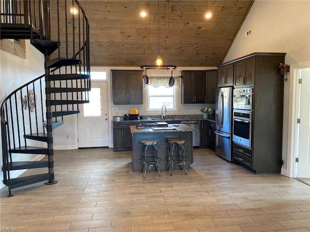 kitchen with a center island, appliances with stainless steel finishes, wood ceiling, high vaulted ceiling, and dark brown cabinets