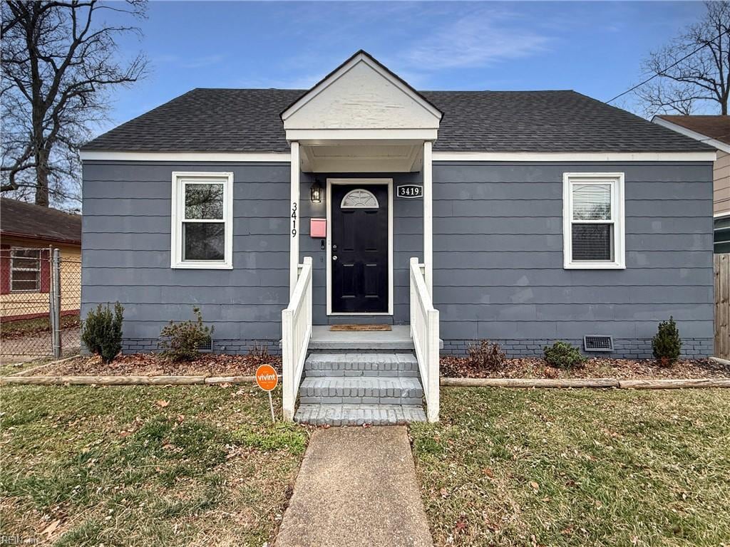 bungalow-style house featuring a front yard