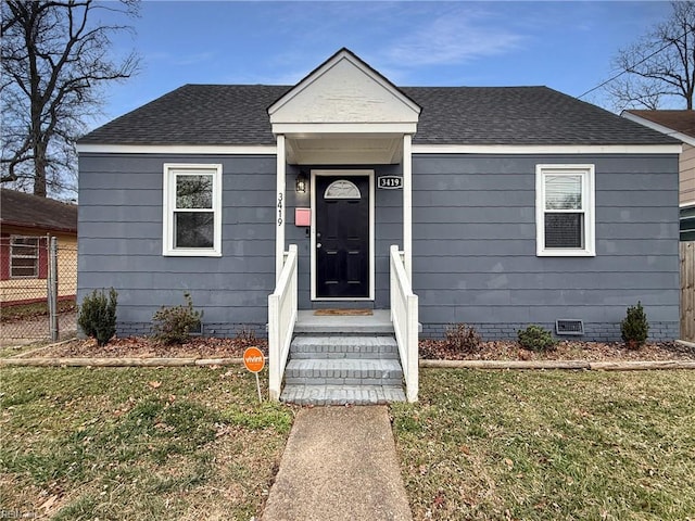 bungalow-style house featuring a front yard