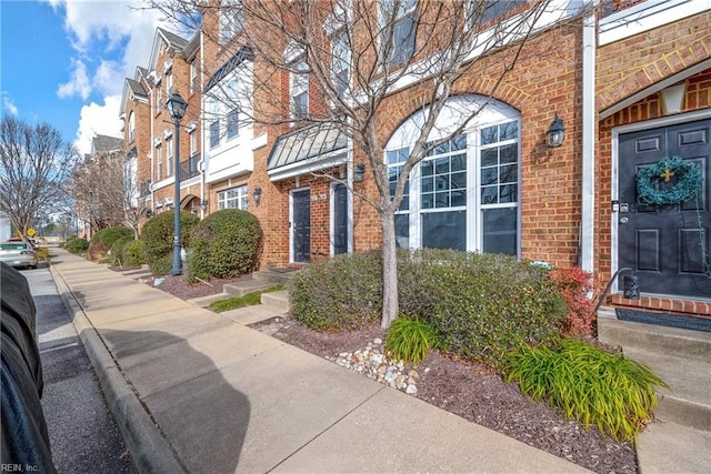 exterior space featuring brick siding