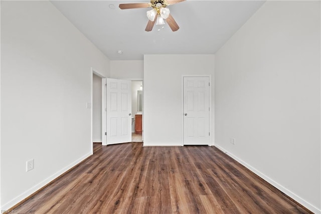 unfurnished bedroom featuring dark wood-style flooring, a ceiling fan, and baseboards