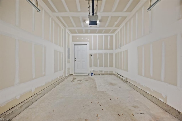 garage featuring a garage door opener and a baseboard heating unit