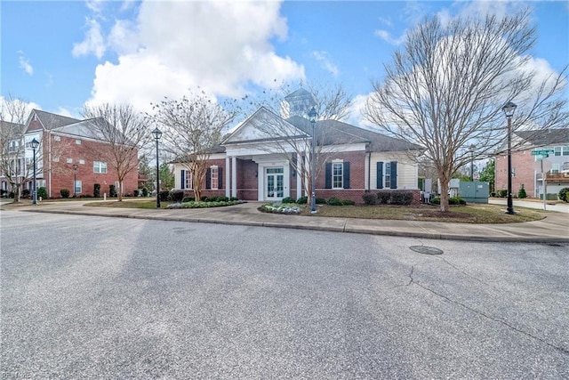 view of front of home featuring french doors and brick siding