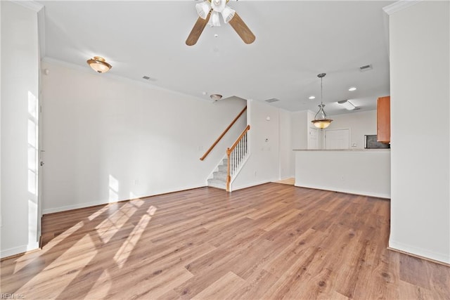 unfurnished living room featuring ceiling fan, visible vents, baseboards, light wood-style floors, and stairway