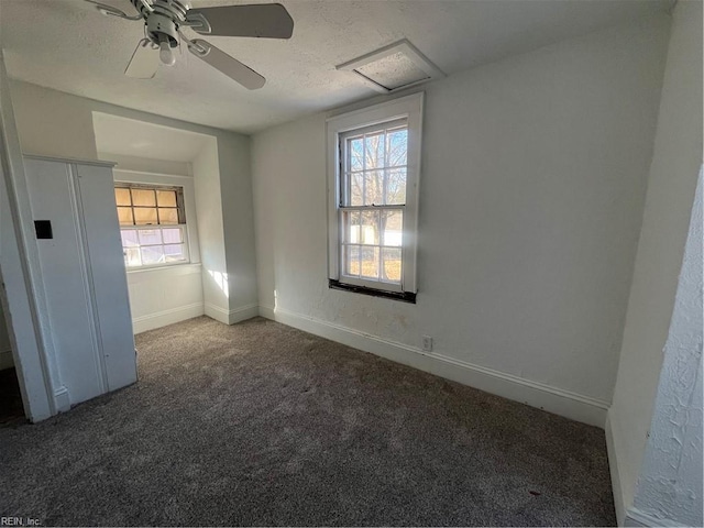 carpeted empty room featuring ceiling fan