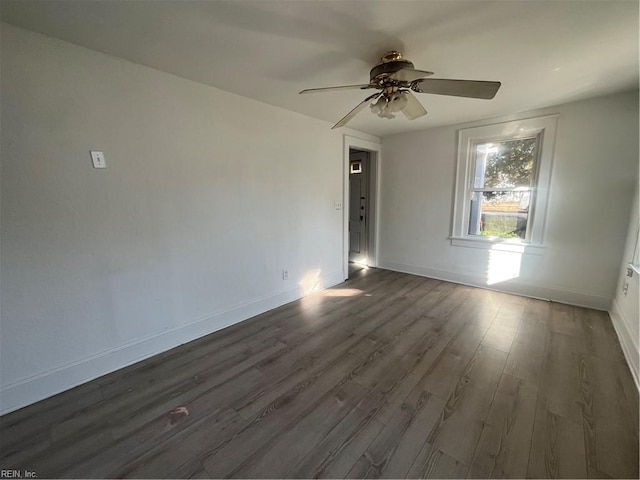 spare room with ceiling fan and dark hardwood / wood-style floors