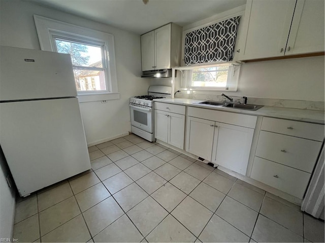 kitchen with white cabinets, light tile patterned floors, white appliances, and sink