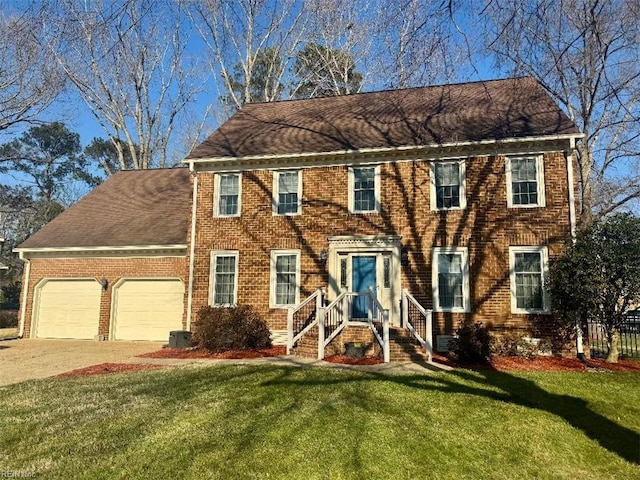 colonial inspired home featuring cooling unit, a front yard, and a garage