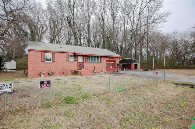 back of house featuring a lawn and a carport