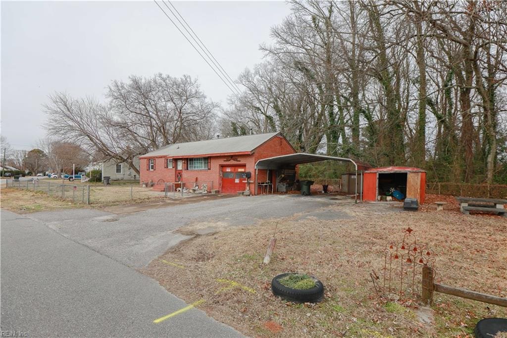 view of front of house featuring a shed and a carport