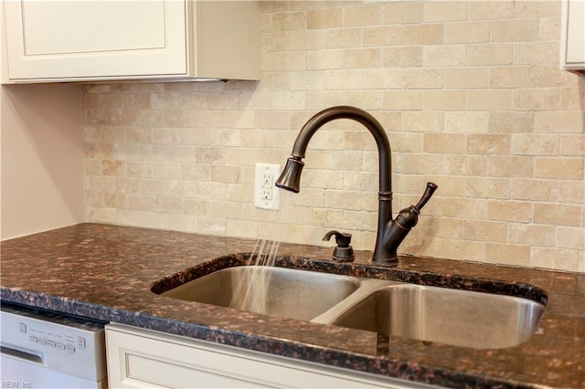 interior details featuring white cabinets, decorative backsplash, sink, and white dishwasher