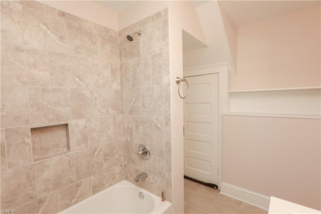 bathroom featuring tile patterned flooring and tiled shower / bath