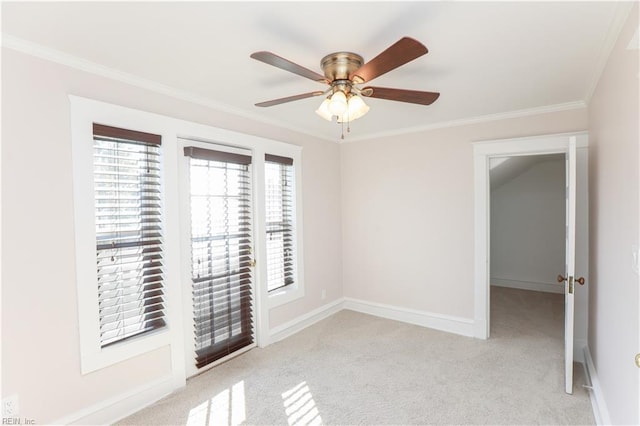 carpeted empty room featuring ceiling fan and ornamental molding