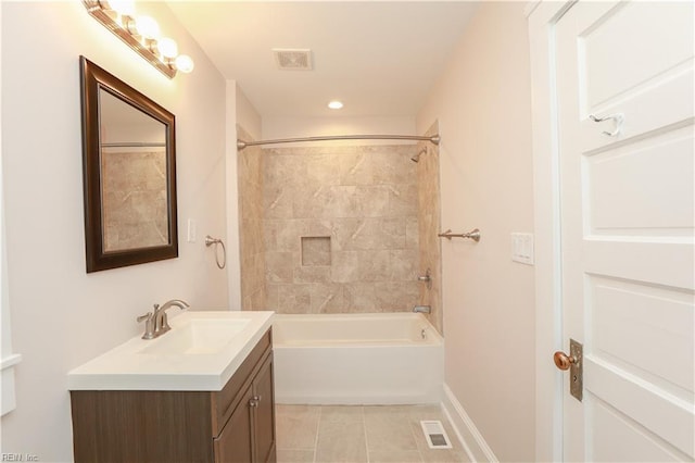 bathroom featuring tile patterned floors, vanity, and tiled shower / bath